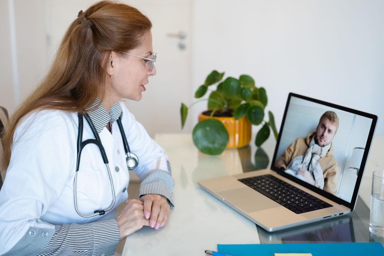 Patient consulting a rheumatologist via secure video call from home