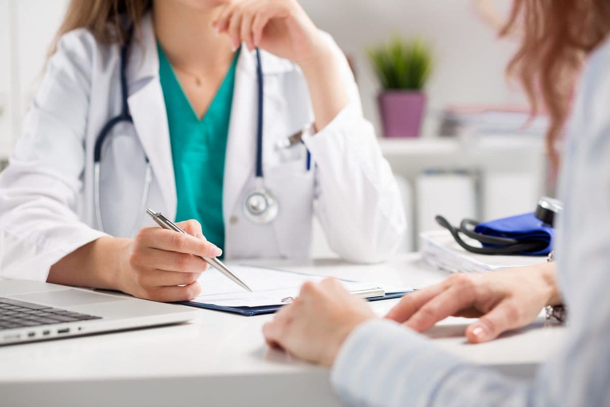 Doctor performing an in-person physical examination